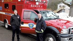 Firefighter Kyle Blake (left) and Fire Chief Steven Locke with the unmanned ambulance