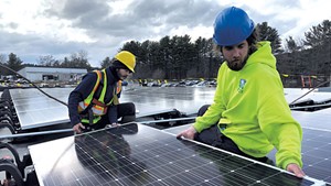 Norwich Solar workers installing a new PV system on a business in White River Junction last week