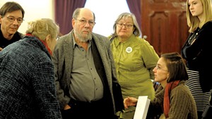 Sen. Jeanette White, left, speaking with Stuart Savel, center, and Emily Amanna, seated, from Vermont Home Grown