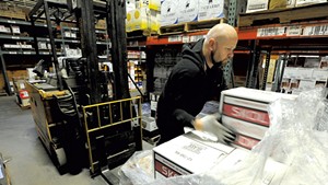 Matt Aubut unloading a pallet of vodka at the Department of Liquor Control warehouse