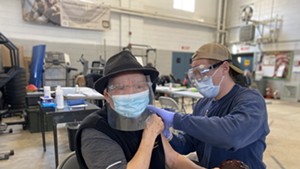 Gốc Văn Trần gets vaccinated for COVID-19 at the Winooski Armory