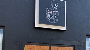 The skeleton sign above the door at Good Trouble