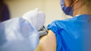 A patient receiving a vaccine dose
