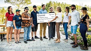 Karen Lawson presenting a check to Downstreet Housing in 2019