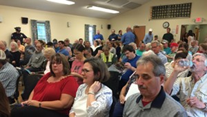 More than 100 people crowd a Rutland Board of Aldermen meeting.
