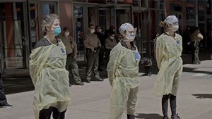 VIRAL DOUBTS Health care workers face anti-lockdown protesters in Wang's documentary about the pandemic in China and the U.S.