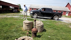 John Belter by the contaminated well on his South Burlington farm in 2019
