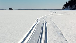 Snowmobile trail on a frozen lake