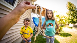 3-year-old Bo and 7-year-old Remy check out a snakeskin
