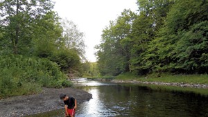 Heather's son Jesse wading in Qu&eacute;bec's Tomifobia River in 2014