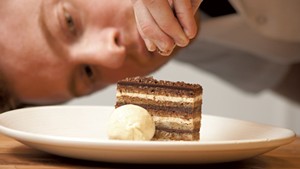 Andrew LeStourgeon completes an opera cake at Hen of the Wood
