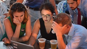 House Speaker Shap Smith reviews election results last Tuesday at Breakwater Café & Grill with campaign manager Erika Wolffing (left) and supporter Candace Morgan.