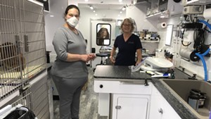 Deb Glottmann, left, and Susan Riggs in the Mitzvah Fund's mobile vet clinic