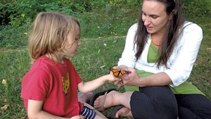 Fin and Naomi studying a monarch butterfly