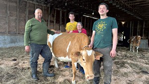Earl Ransom and his wife, Amy Huyffer, with their sons Harley and Jackson Ransom and Pomegranate the cow