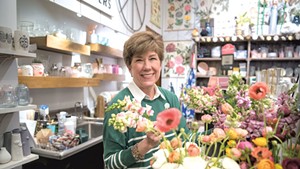Jana Qualey, co-owner of Home &amp; Garden Vermont, arranging fresh flowers in Burlington