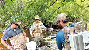 Left to right: Luke Holland, Jud Kratzer and Levi Brown with electrofishing gear