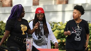 Tyeastia Green (center) with supporters Kiah Morris, left, and Ferene Paris Meyer, right