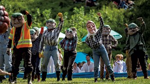 Chelsea Edgar (center back) performing as a garbageman at Bread and Puppet Theater