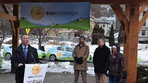 Gov. Phil Scott (left) joins SunCommon cofounder (second from left) James Moore at a press conference Monday.