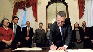 Gov. Phil Scott signing an executive order calling on state government to make Vermont more "affordable"