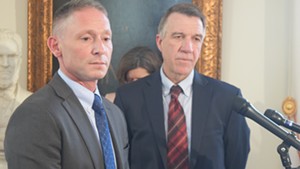 Commerce Secretary Michael Schirling (left) and Gov. Phil Scott talk Tuesday about the proposed agency reorganization.