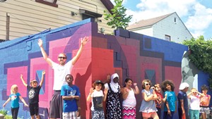 Sloan Collins and his helpers in front of a mural supported by the BCA Community Fund