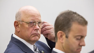Norm McAllister (left) listening in court with attorney Brooks McArthur during his first trial, in June