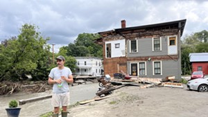 Eli Barlow standing in the spot where his second-floor apartment used to be