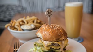 Double-stack smash burger with hand-cut fries and an Elaborate Metaphor pale ale