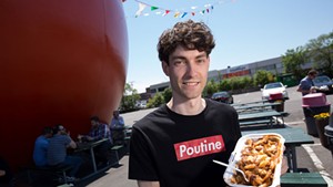 Nicolas Fabien-Ouellet, a student in the University of Vermont's Food Systems Master's program, with an order of poutine from Orange Jules in Montreal.