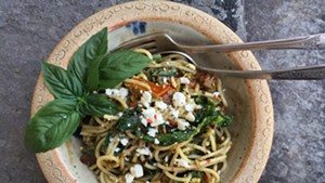Pasta tossed with wilted kale, tomatoes, feta and pesto.