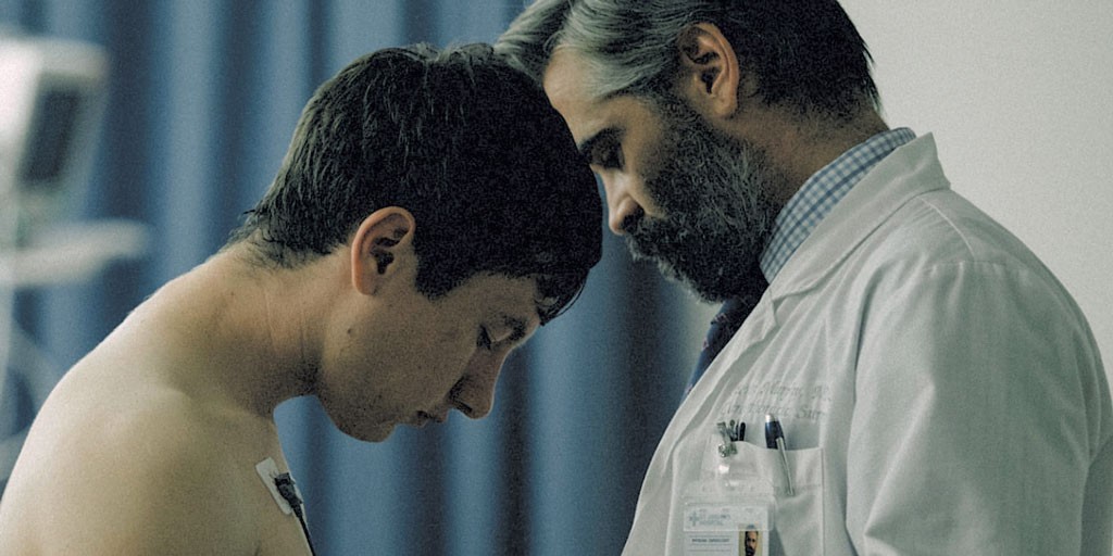 GOD COMPLEX Farrell plays a cardiologist navigating a perilous situation in Lanthimos’ pitch-dark, hyperreal drama.