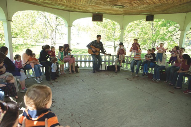 Derek Burkins leads kids in a music lesson