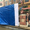 A tarp covering the mural after the Halloween vandalism