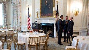 United States President Barack Obama talks with Governor Peter Shumlin of Vermont, centre, chair of the Democratic Governors Association, and Governor Mike Pence of Indiana, after a meeting with the National Governors Association in the State Dining Room of the White House on 25 February 2013.