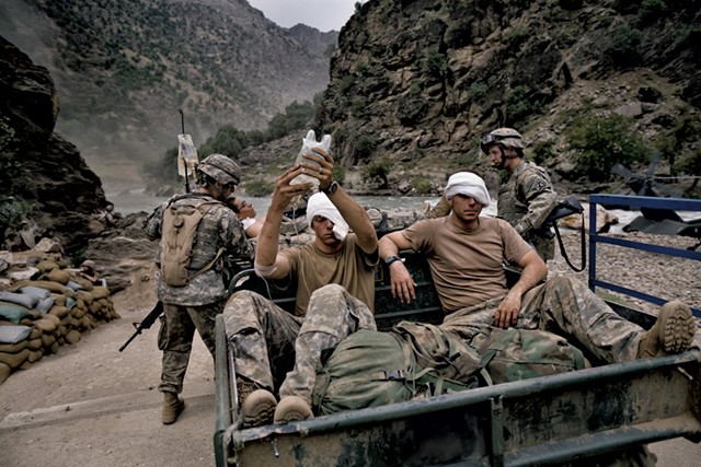 Wounded U.S. Army soldiers  await evacuation by helicopter from Kamdesh, Nuristan province. - COURTESY OF ROBERT NICKELSBERG